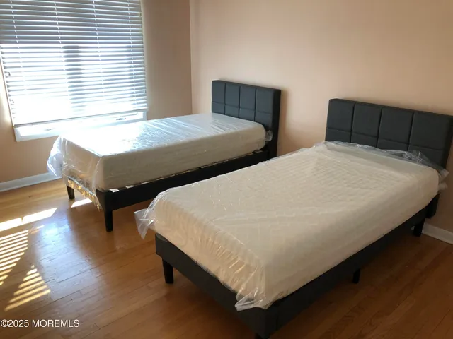 a bed sitting in a bedroom next to a window