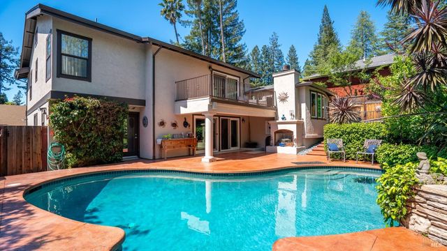a view of a patio with table and chairs potted plants and large tree