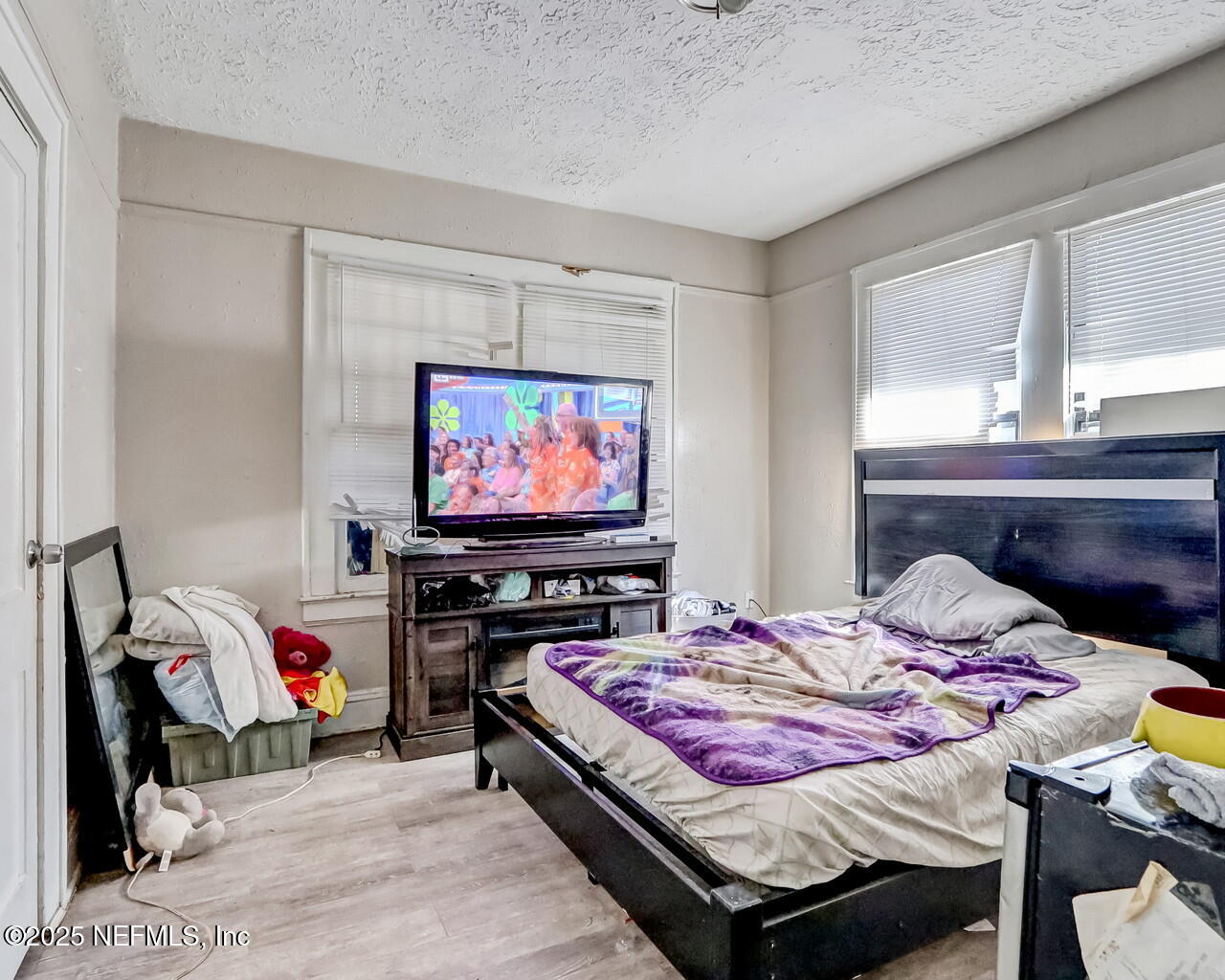 446 West 26th Street Jacksonville, FL 32206 - Photo 14 of 19 a bedroom with a bed and a flat screen tv