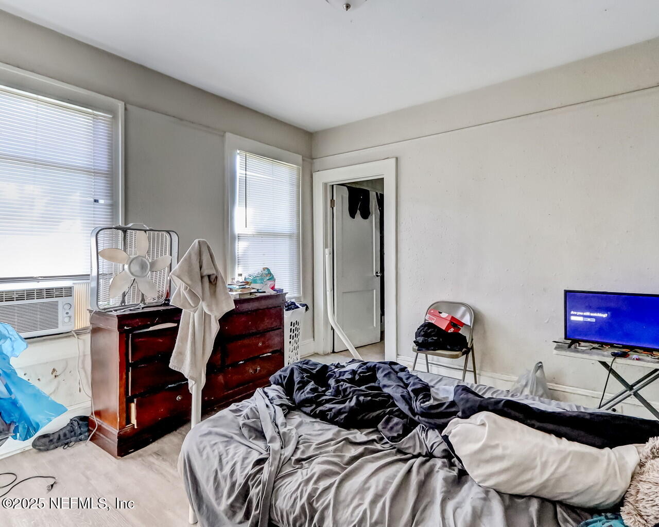 446 West 26th Street Jacksonville, FL 32206 - Photo 16 of 19 a bedroom with a bed and a chandelier