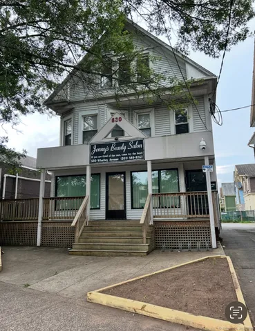 a view of a house with a balcony and furniture