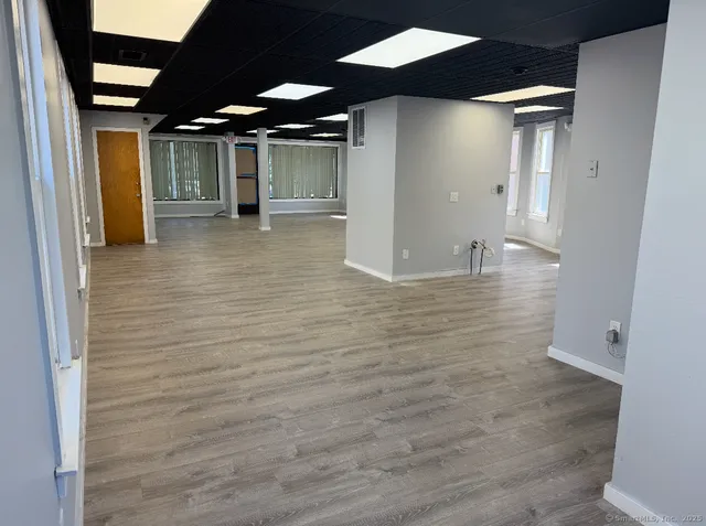 a view of a hallway with a wooden cabinets