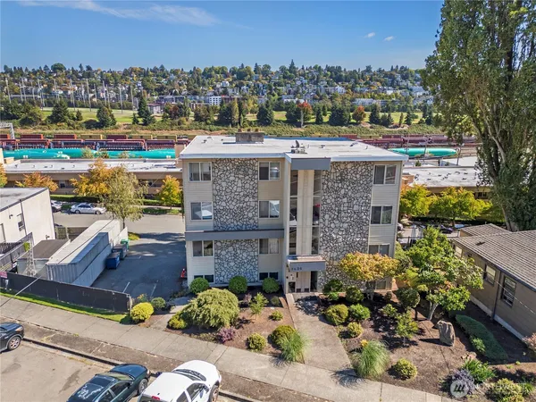 an aerial view of a house with a garden and lake view