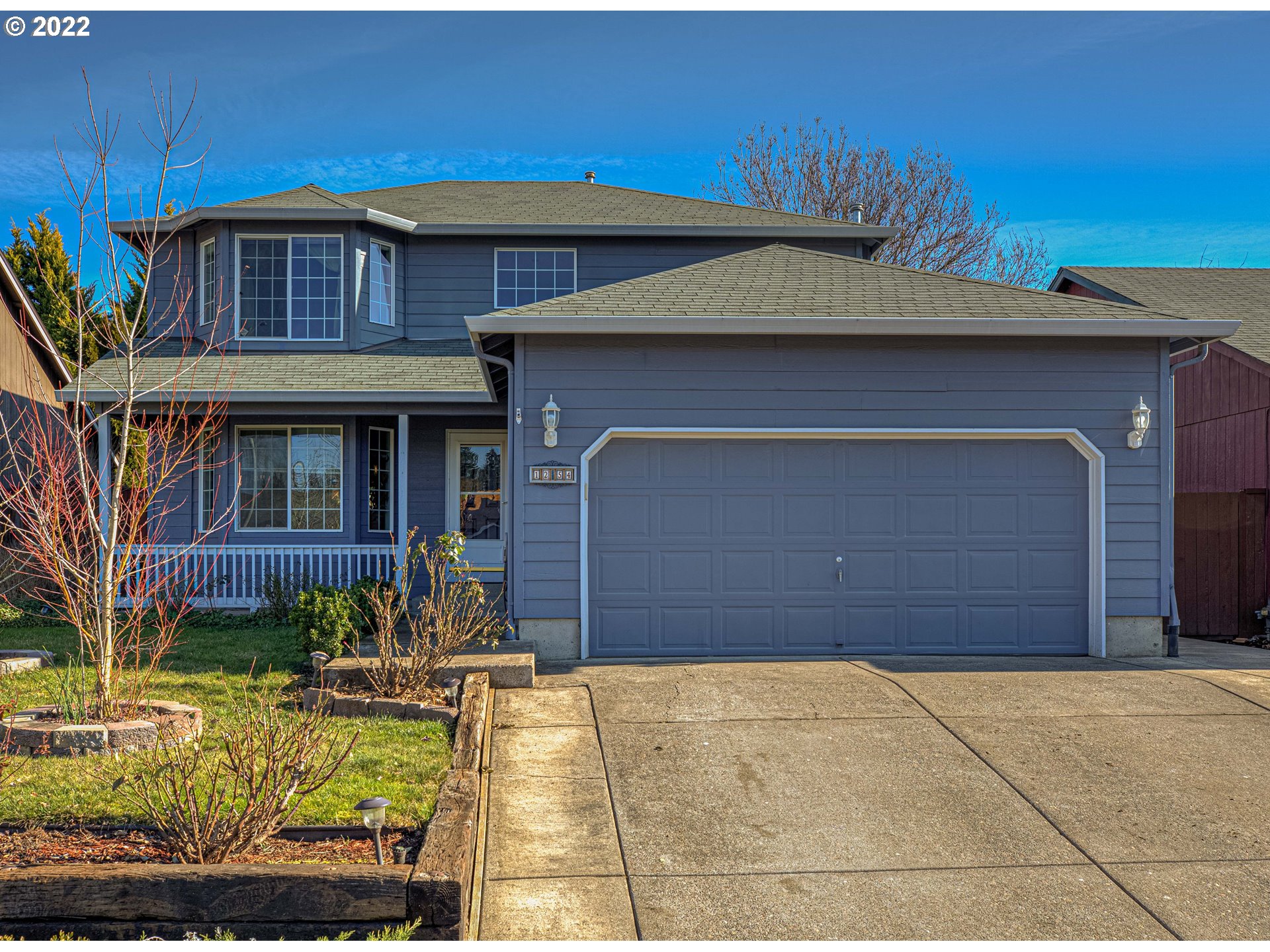a front view of a house with garden