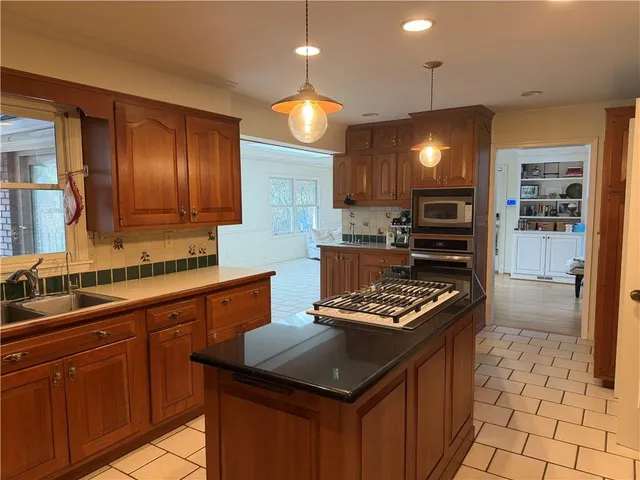 a kitchen with a sink stove and cabinets
