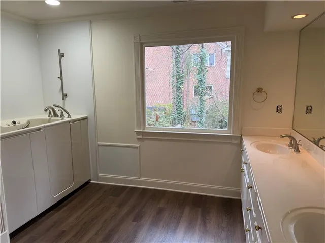 a spacious bathroom with double vanity sink and a mirror