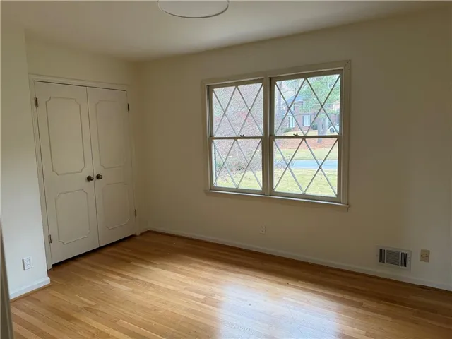 a bathroom with a sink a toilet and a window