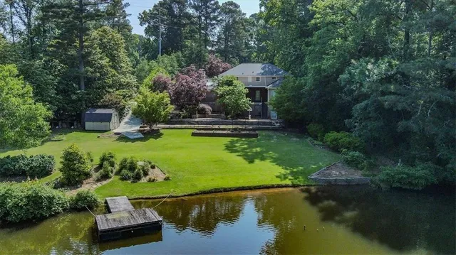 a view of a house with pool outdoor seating yard and lake view