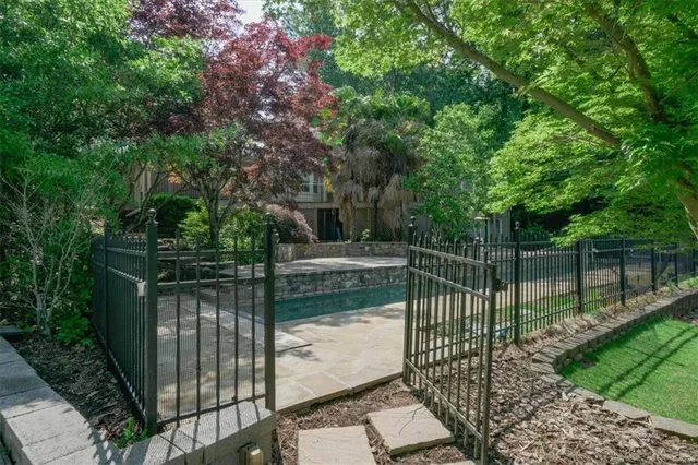 a view of backyard with lake and trees