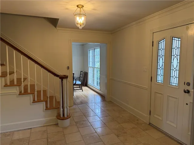 a view of entryway and hall with wooden floor