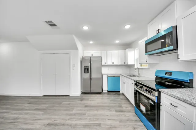 a view of a kitchen with a microwave and a dishwasher