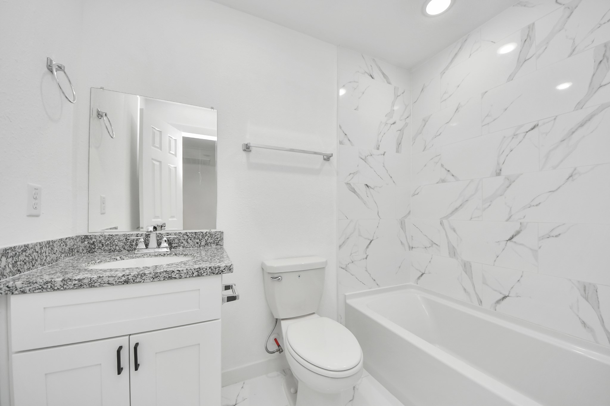 2310 Wavell Street, Unit B Houston, TX 77088 - Photo 19 of 31 a bathroom with a granite countertop sink a toilet and a bathtub