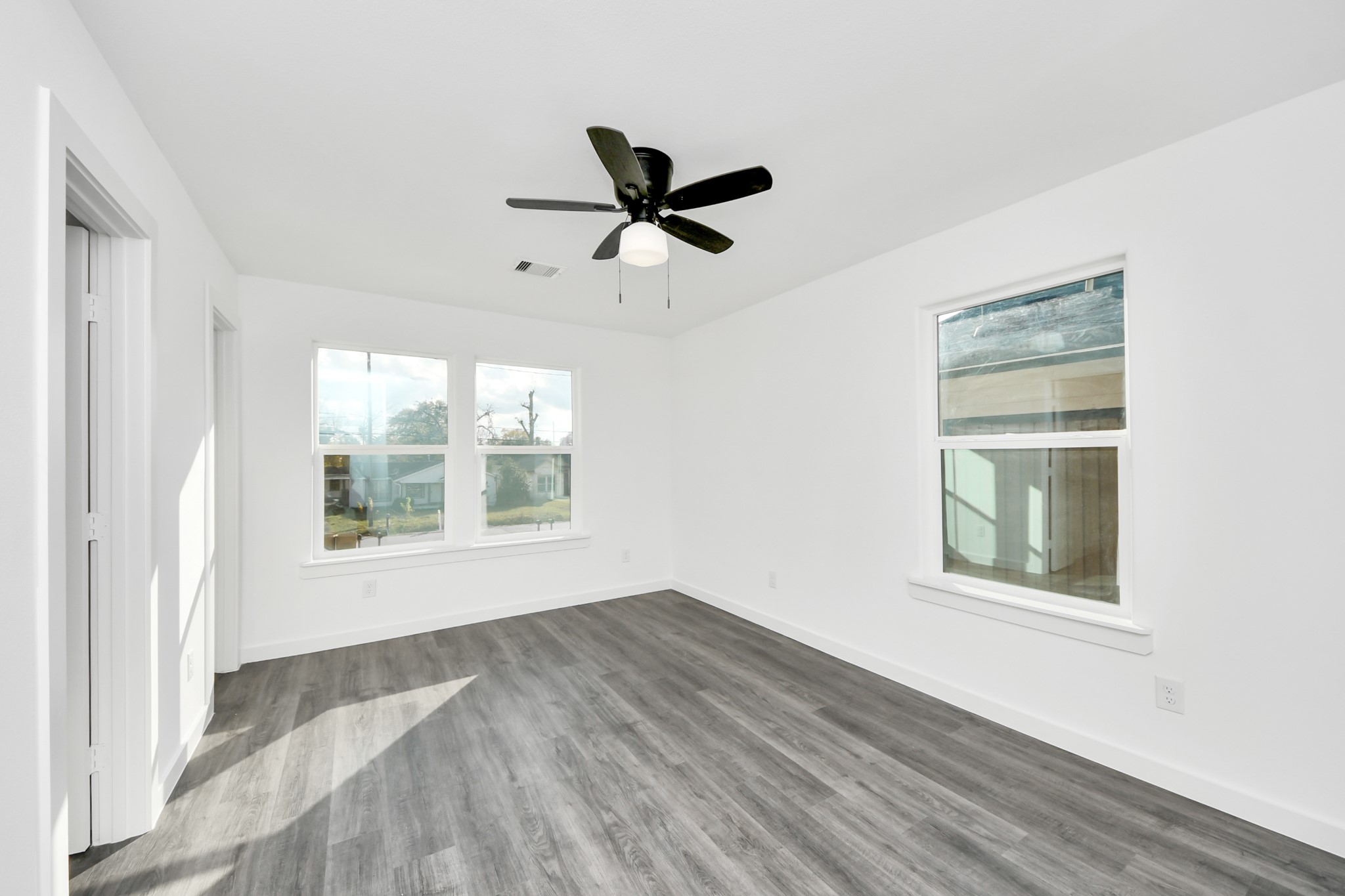 2310 Wavell Street, Unit B Houston, TX 77088 - Photo 20 of 31 a view of an empty room with a window and wooden floor