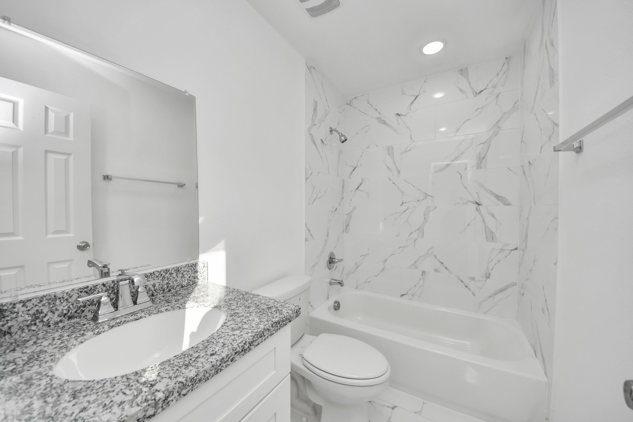 2310 Wavell Street, Unit B Houston, TX 77088 - Photo 22 of 31 a bathroom with a granite countertop sink toilet mirror and bathtub