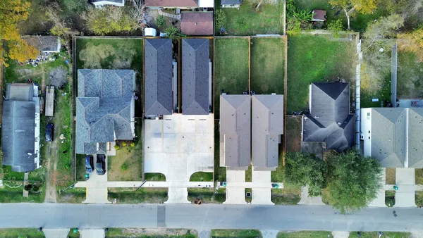 an aerial view of a house with a garden and yard