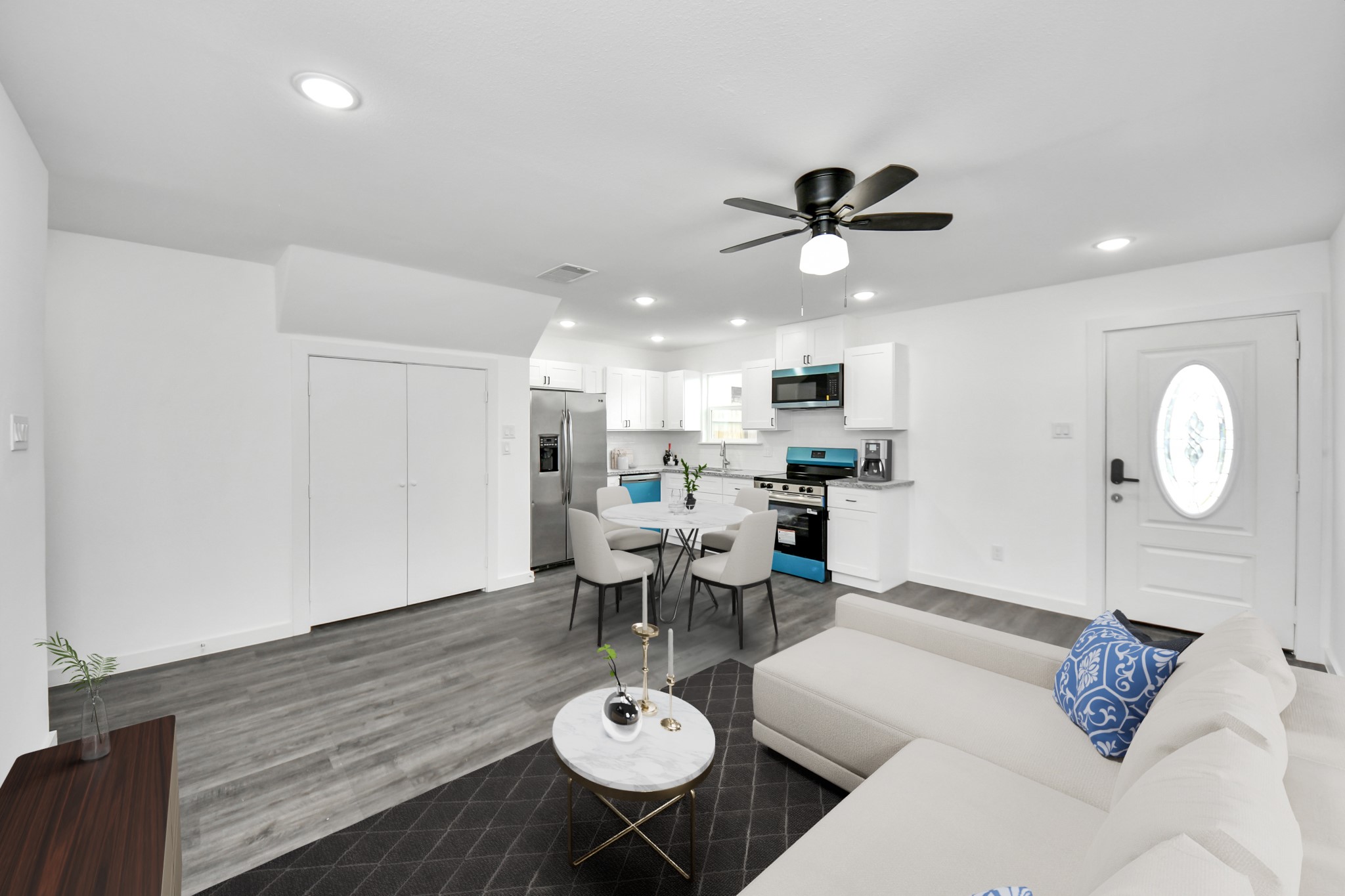 2310 Wavell Street, Unit B Houston, TX 77088 - Photo 5 of 31 a living room with furniture a chandelier and a dining room