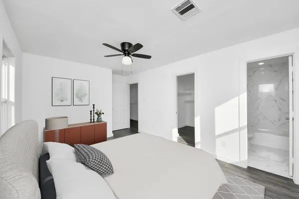 a bedroom with a large bed and a chandelier