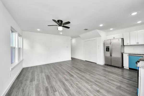 a view of a kitchen with a sink and a refrigerator