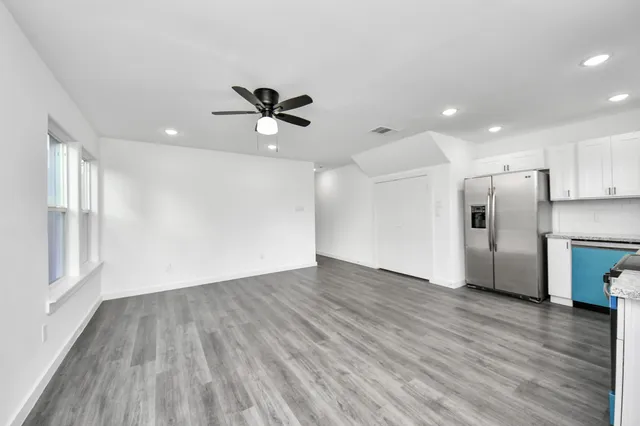 a view of a kitchen with a sink and a refrigerator