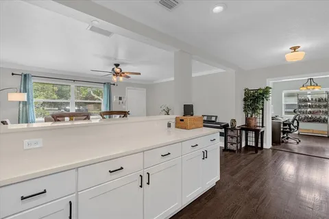 a kitchen with a sink cabinets and wooden floor