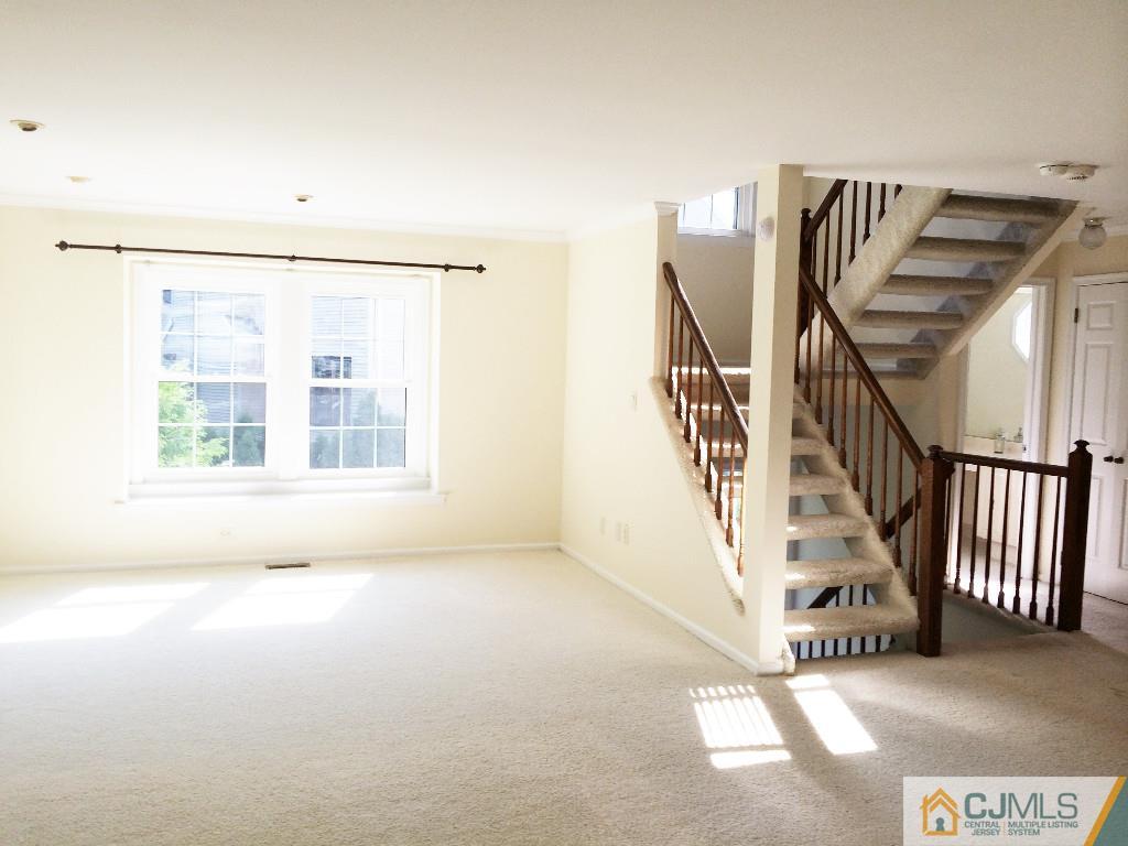 4607 Stonehedge Road Edison, NJ 08820 - Photo 8 of 10 a view of an empty room with stairs
