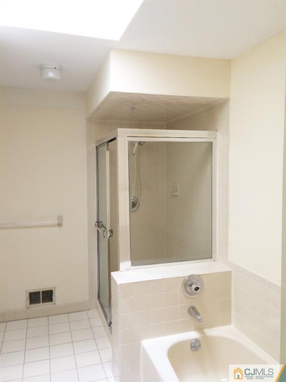4607 Stonehedge Road Edison, NJ 08820 - Photo 9 of 10 a bathroom with a tub and shower
