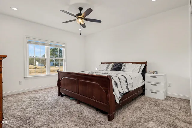 a spacious bedroom with a bed and a window