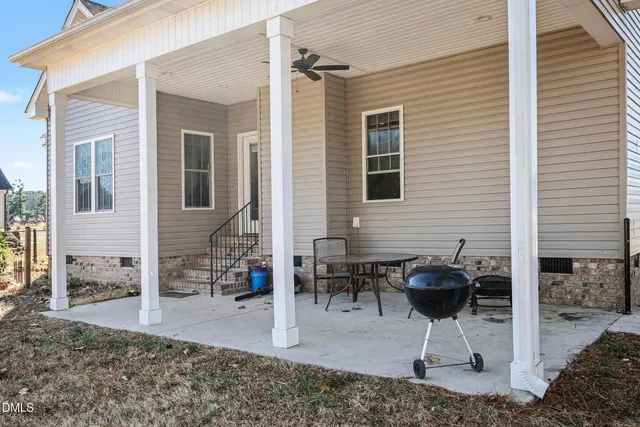 a view of a house with backyard and a patio