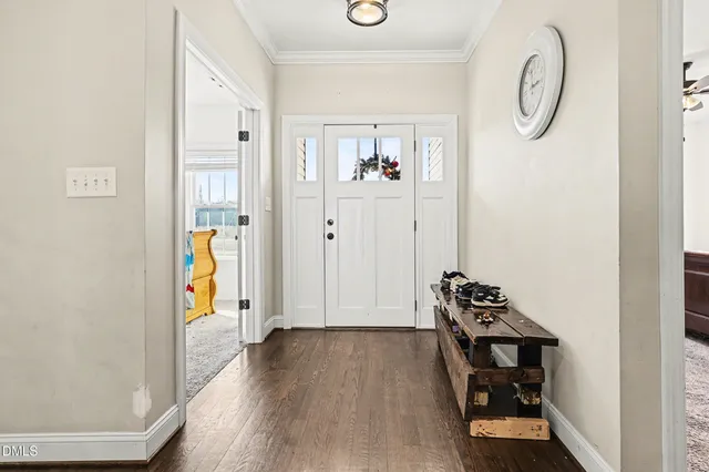 a view of a hallway with wooden floor and closet