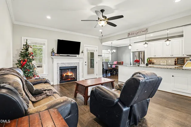 a living room with furniture fireplace and a flat screen tv