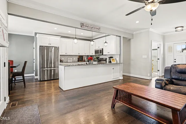 a kitchen with kitchen island a stove and a refrigerator