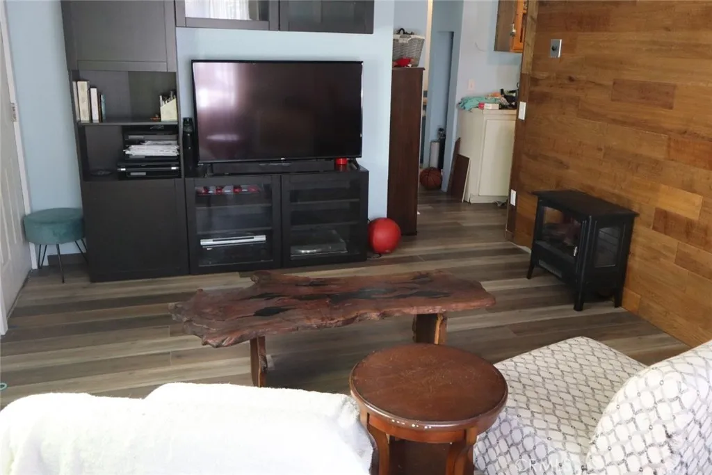 15325 Orange, Unit F16 Paramount, CA 90723 - Photo 11 of 25 a living room with furniture and a flat screen tv