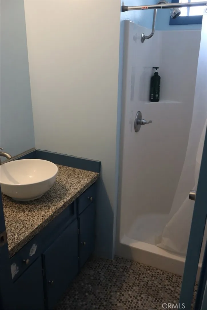 15325 Orange, Unit F16 Paramount, CA 90723 - Photo 12 of 25 a bathroom with a granite countertop sink and toilet