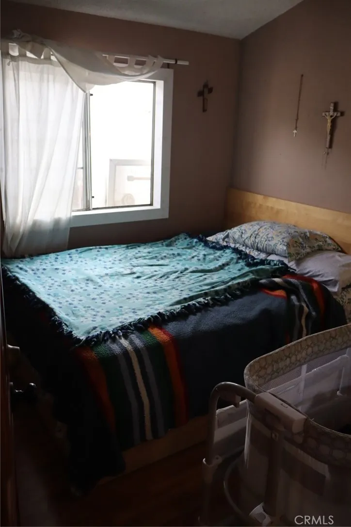 15325 Orange, Unit F16 Paramount, CA 90723 - Photo 15 of 25 a bedroom with a bed and a window