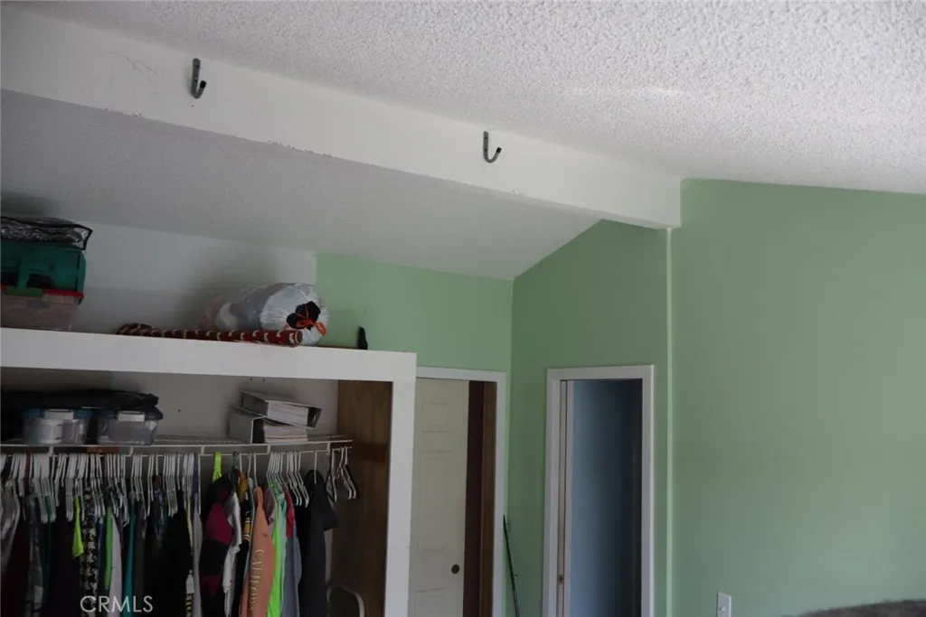 15325 Orange, Unit F16 Paramount, CA 90723 - Photo 17 of 25 a view of a hallway with closet