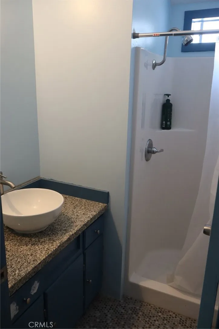 15325 Orange, Unit F16 Paramount, CA 90723 - Photo 20 of 25 a bathroom with a granite countertop sink and mirror