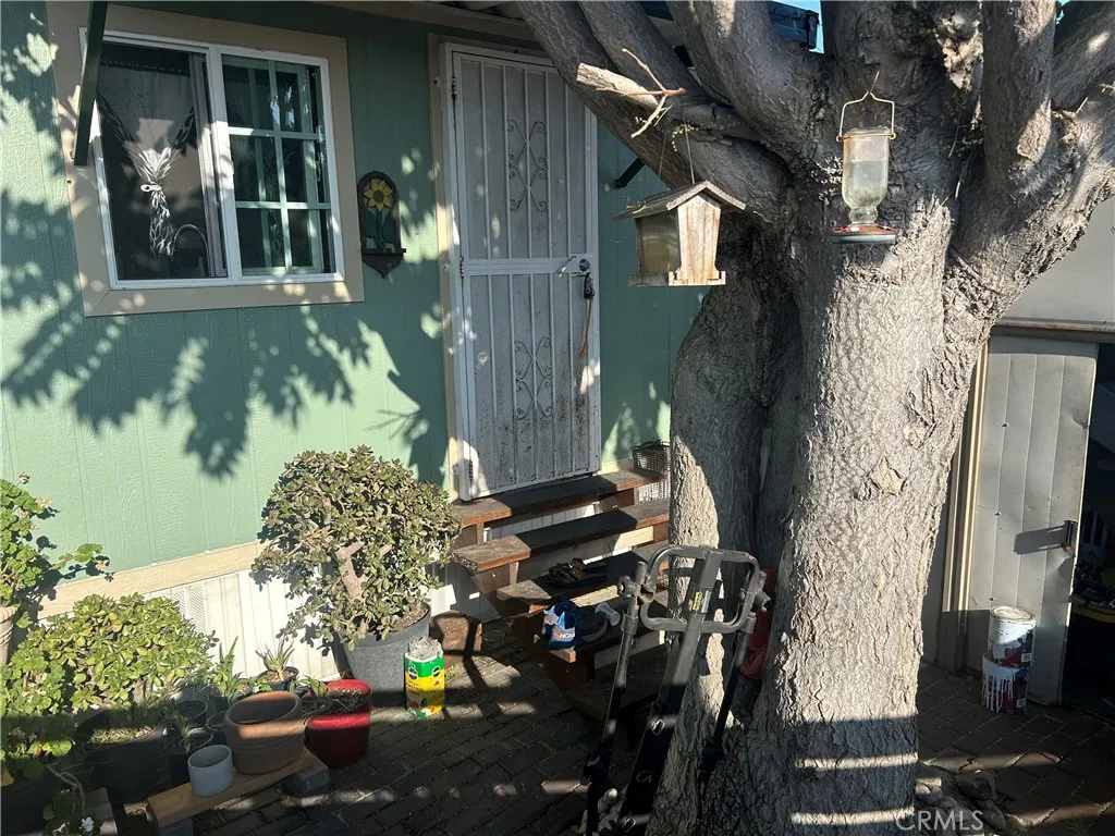 15325 Orange, Unit F16 Paramount, CA 90723 - Photo 22 of 25 a front view of a house with a yard