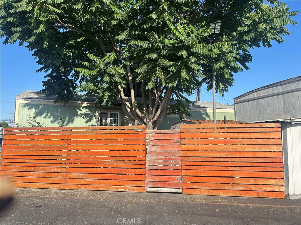 15325 Orange, Unit F16 Paramount, CA 90723 - Photo 25 of 25 a backyard of a house with a tree