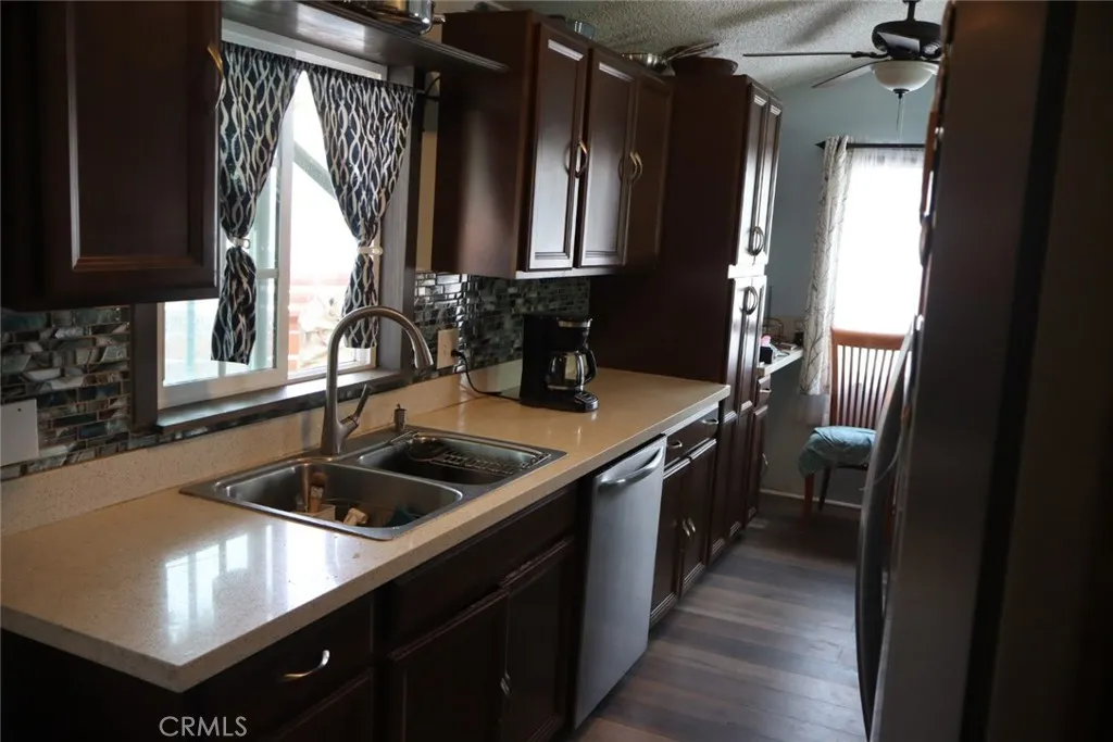 15325 Orange, Unit F16 Paramount, CA 90723 - Photo 6 of 25 a kitchen with a sink stove and refrigerator