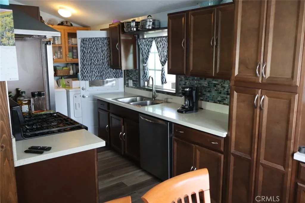 15325 Orange, Unit F16 Paramount, CA 90723 - Photo 7 of 25 a kitchen with a sink stove and refrigerator