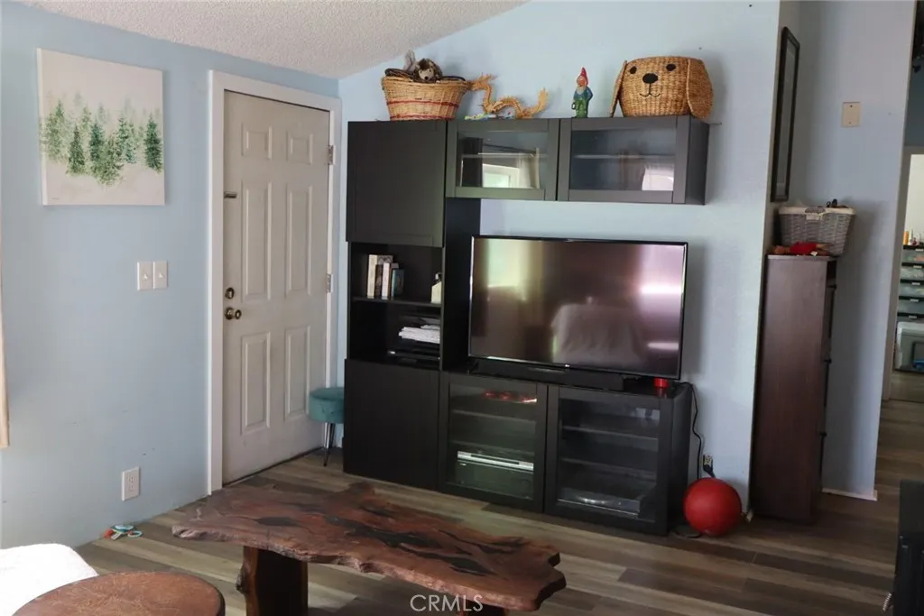 15325 Orange, Unit F16 Paramount, CA 90723 - Photo 9 of 25 a living room with furniture and a flat screen tv