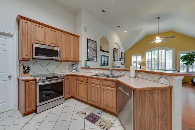 a kitchen with stainless steel appliances granite countertop a sink and a stove