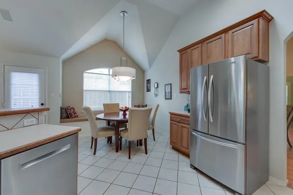 a kitchen with stainless steel appliances a refrigerator and a stove top oven