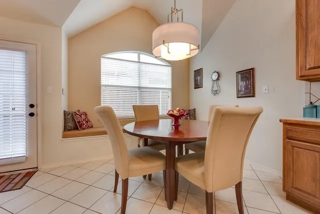 a view of a dining room with furniture and a chandelier