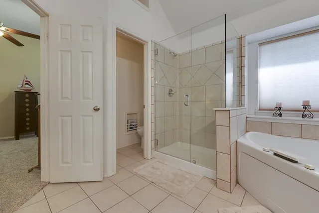 a bathroom with a shower and a sink