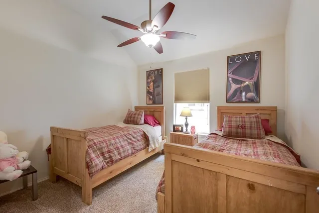 a bedroom with a large bed and a window