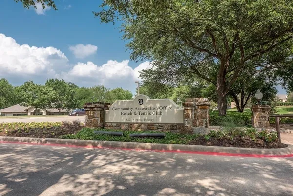 a front view of a house with a yard and fountain