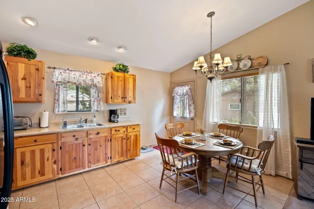 a view of a dining room and kitchen with stainless steel appliances granite countertop a stove a sink a dining table and chairs