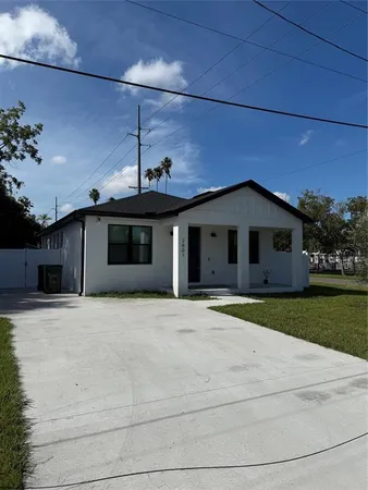 a front view of a house with a garden and yard