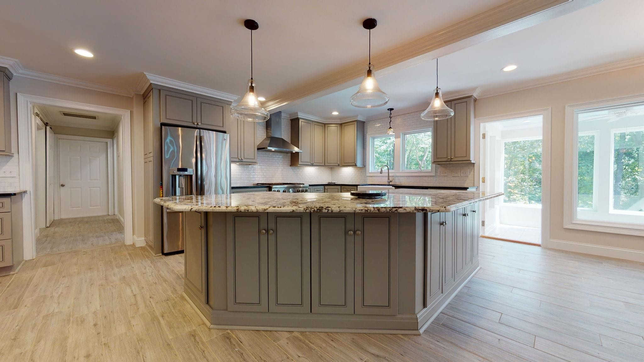 5308 Craig Road Durham, NC 27712 - Photo 16 of 46 a kitchen with stainless steel appliances granite countertop a sink a stove a refrigerator and island with wooden floor